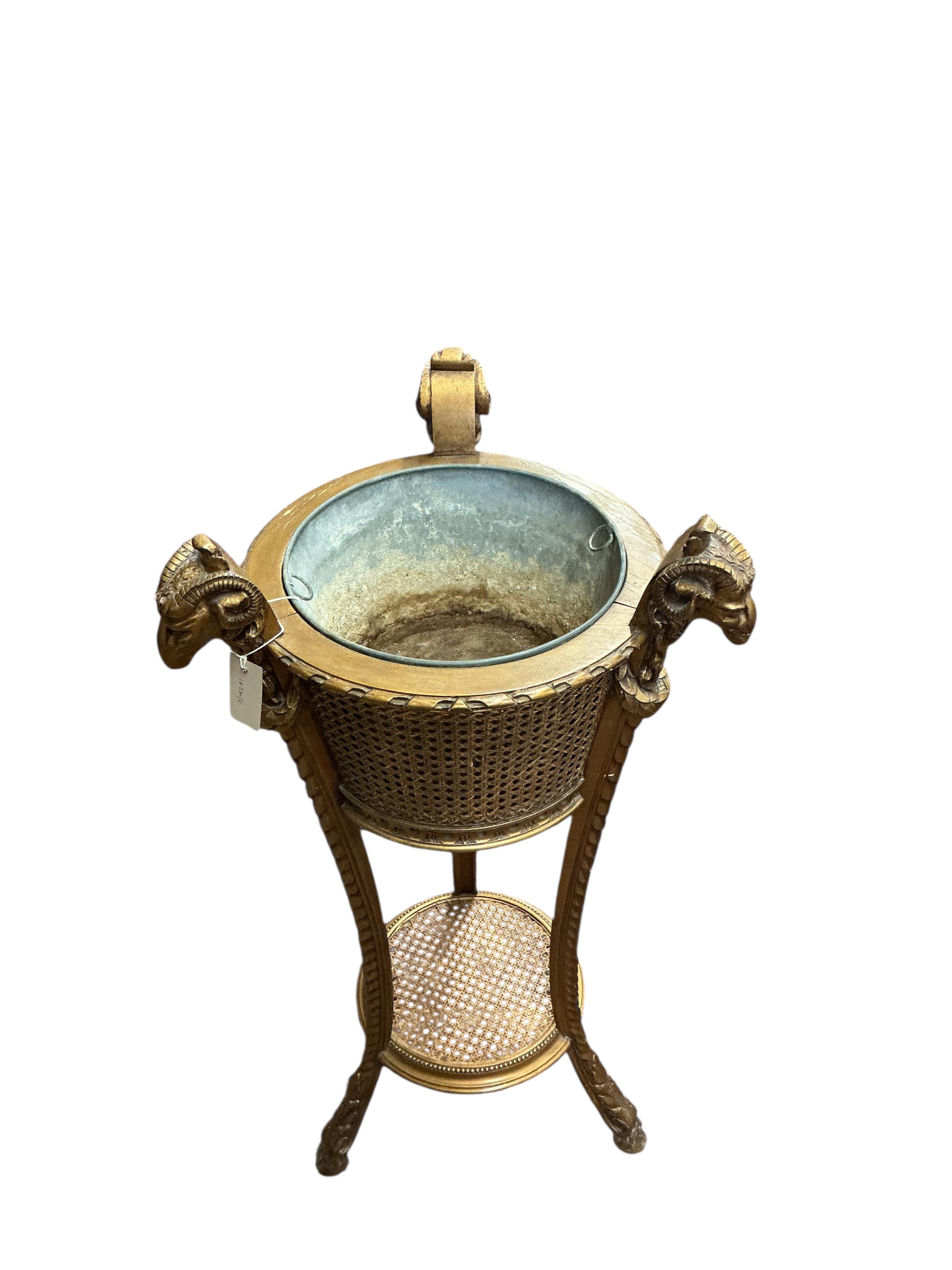 A Victorian style caned giltwood jardiniere with ram's head finials, height 99cm